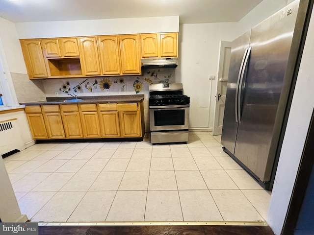 kitchen with radiator, stainless steel appliances, sink, backsplash, and light tile patterned flooring