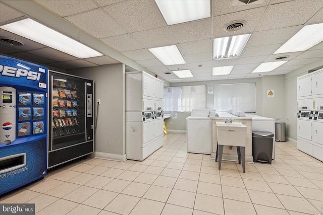 laundry area with washer and dryer, stacked washer / dryer, and light tile patterned floors