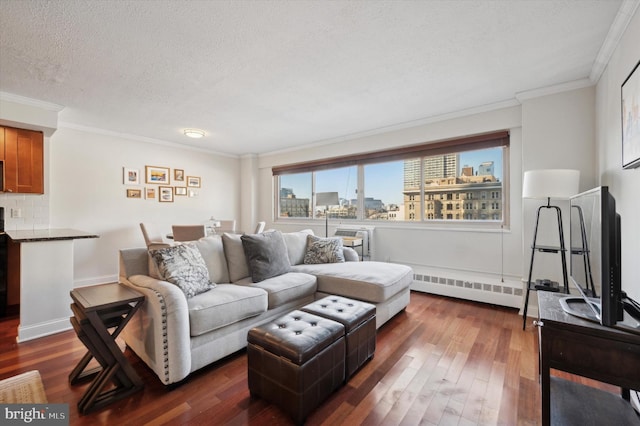 living area featuring a textured ceiling, a baseboard heating unit, dark wood-style flooring, and ornamental molding