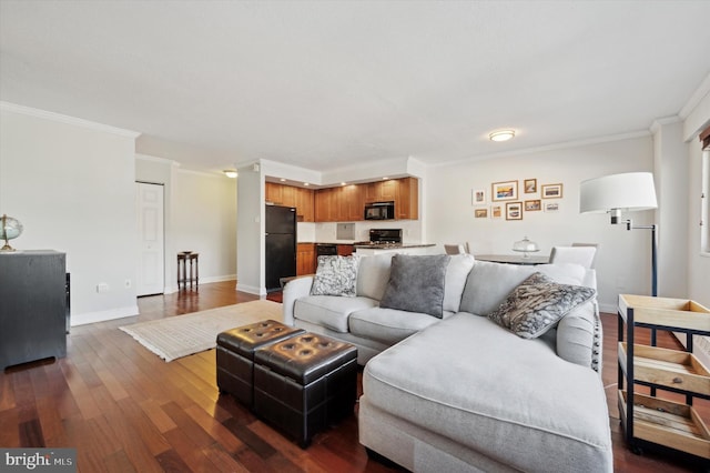 living area featuring dark wood-style floors, baseboards, and ornamental molding