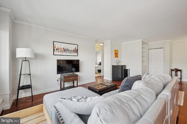 living room featuring crown molding, wood finished floors, and baseboards