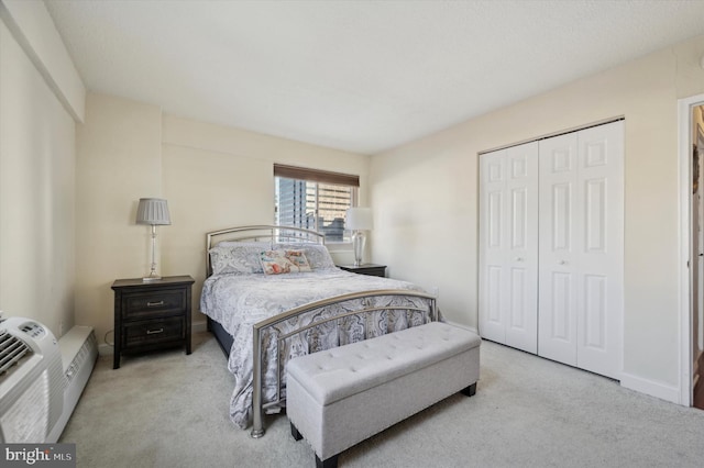 carpeted bedroom featuring a closet and baseboards