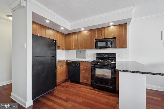 kitchen with crown molding, kitchen peninsula, dark stone counters, and black appliances