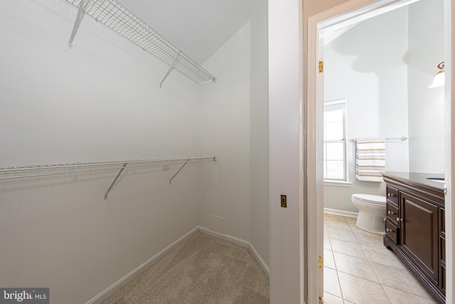 spacious closet featuring light tile patterned floors