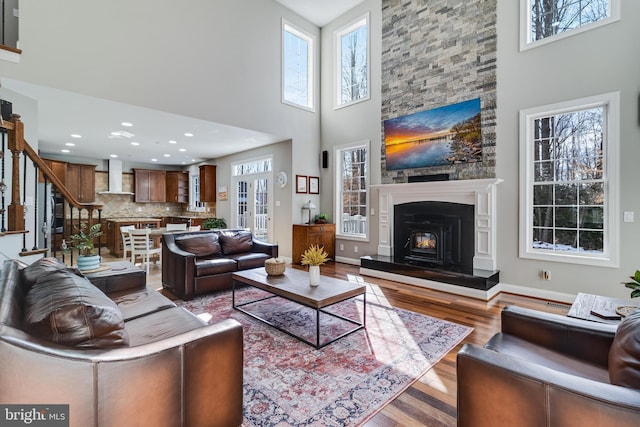 living room with hardwood / wood-style floors and a high ceiling