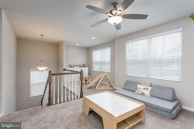 living room featuring carpet and ceiling fan