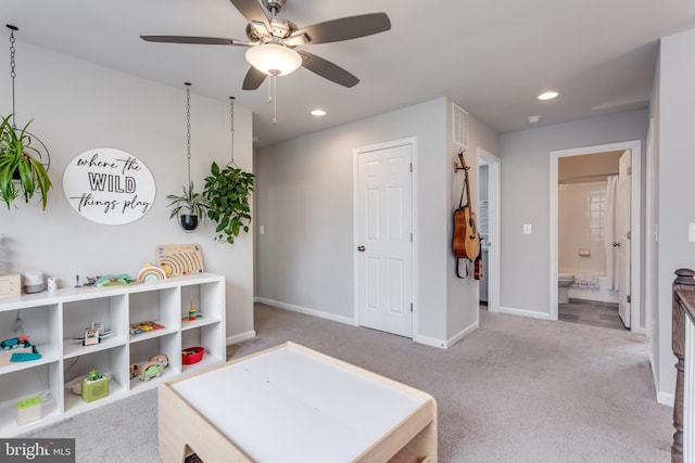 game room with ceiling fan and light carpet