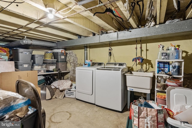 basement featuring separate washer and dryer and sink