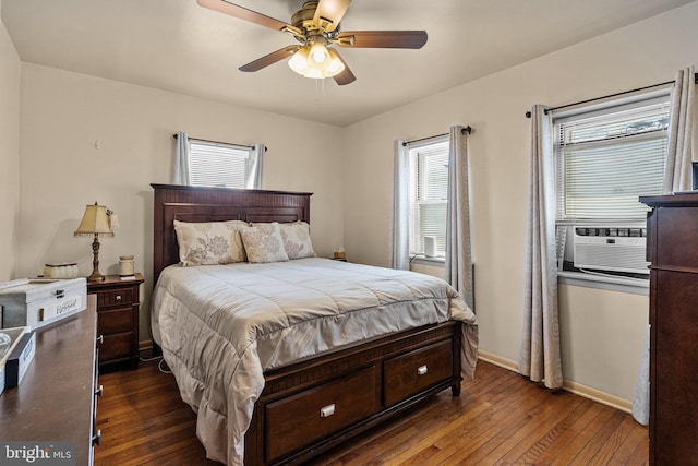 bedroom featuring ceiling fan, cooling unit, and dark hardwood / wood-style floors