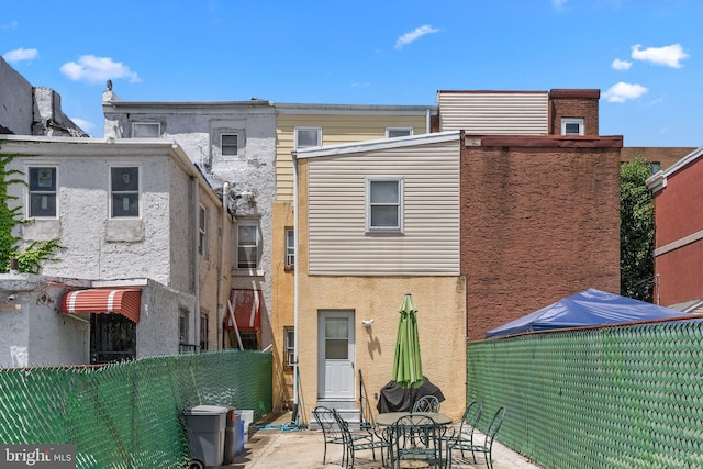 back of property with a patio