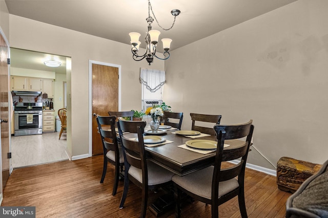 dining room with an inviting chandelier and wood-type flooring