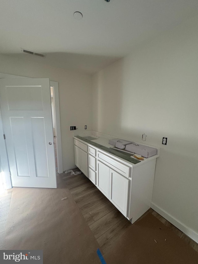 washroom with dark hardwood / wood-style flooring