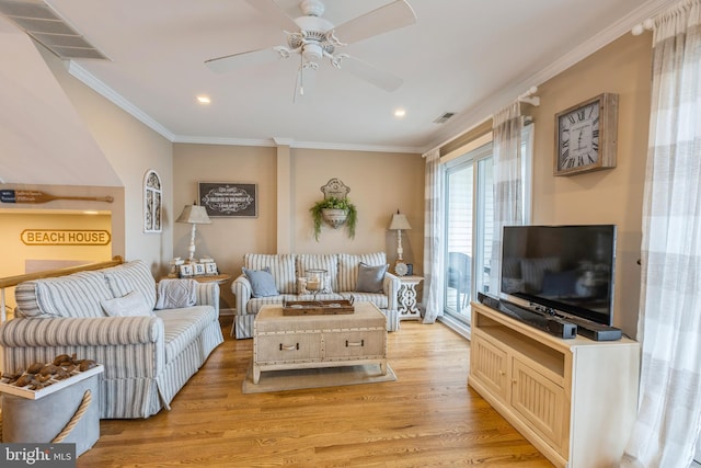 living room with ceiling fan, ornamental molding, and light wood-type flooring