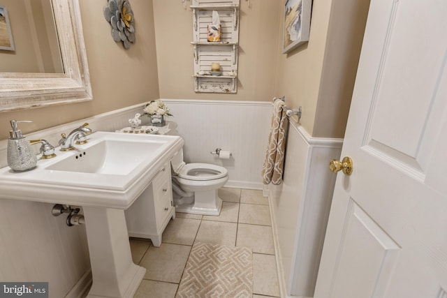 bathroom featuring toilet and tile patterned flooring