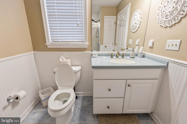 bathroom featuring toilet, vanity, an enclosed shower, and tile patterned flooring