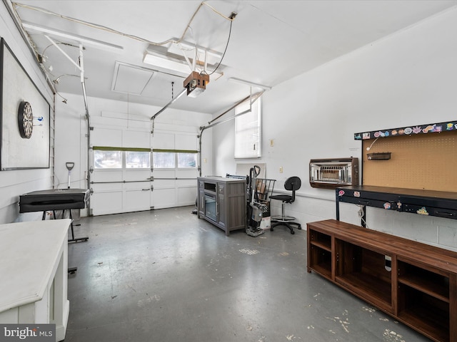 garage featuring a garage door opener and a wall mounted AC