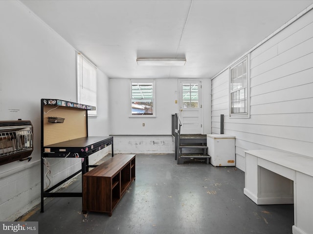 basement with wood walls and heating unit