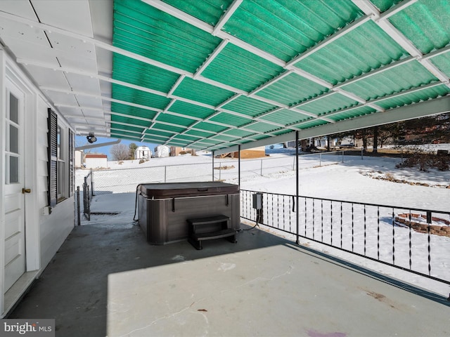 snow covered patio featuring a hot tub