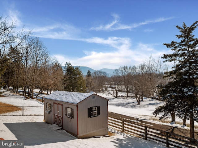 snow covered structure with a mountain view