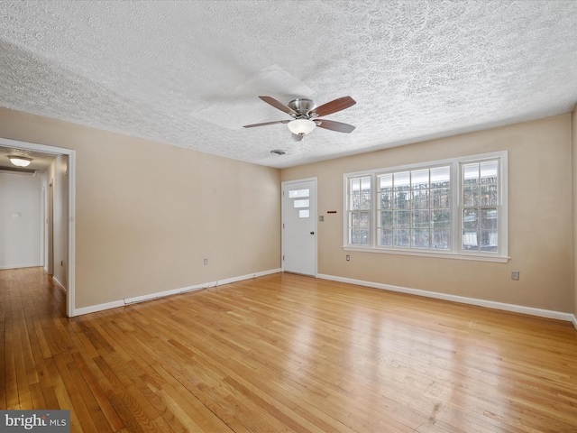 unfurnished living room with light wood-type flooring, ceiling fan, and a textured ceiling