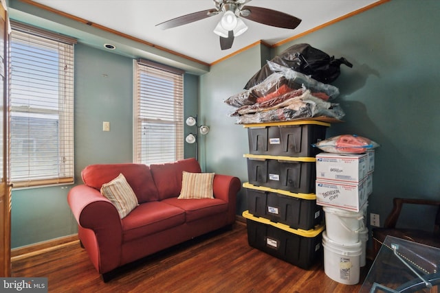 interior space with ceiling fan, ornamental molding, and dark hardwood / wood-style floors