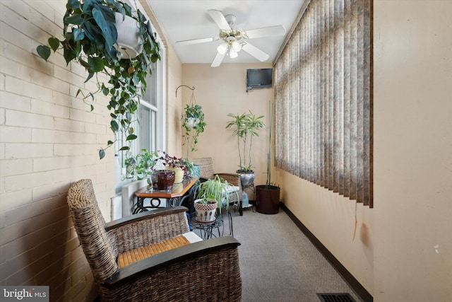 hallway featuring brick wall and carpet flooring