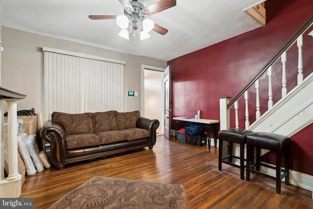 living room featuring ceiling fan and dark hardwood / wood-style floors