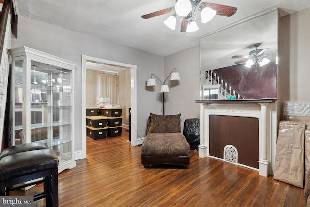 sitting room featuring ceiling fan and dark hardwood / wood-style flooring