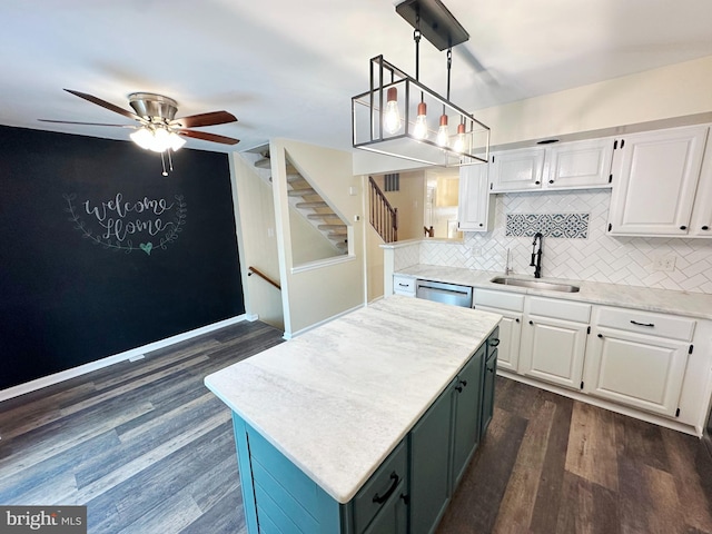 kitchen featuring dark hardwood / wood-style flooring, sink, white cabinetry, and pendant lighting