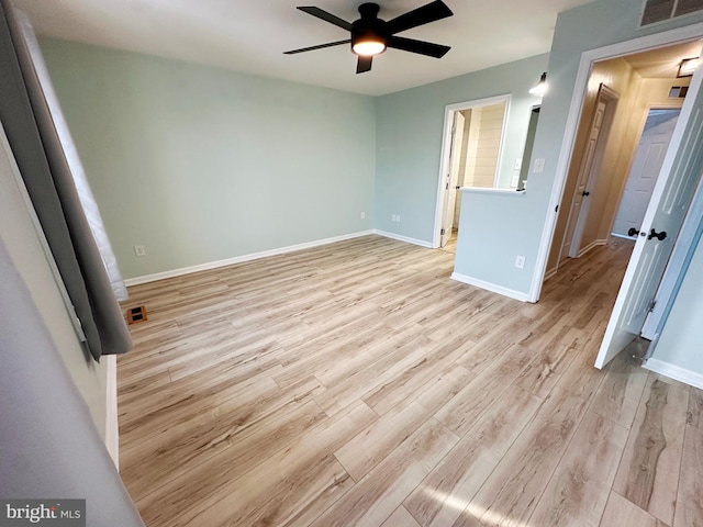 unfurnished bedroom with ceiling fan and light wood-type flooring