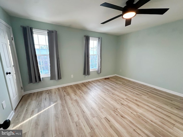 unfurnished room with ceiling fan, plenty of natural light, and light hardwood / wood-style flooring