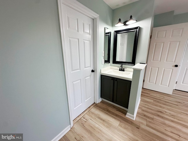 bathroom featuring hardwood / wood-style flooring and vanity