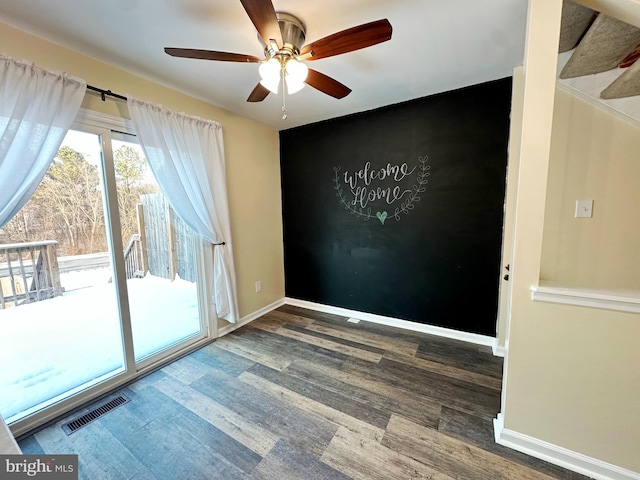 empty room featuring ceiling fan and dark hardwood / wood-style flooring