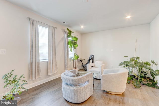 living area with hardwood / wood-style floors