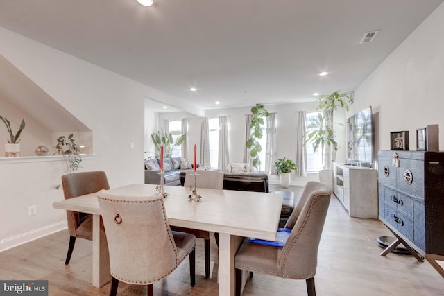 dining space with light wood-type flooring