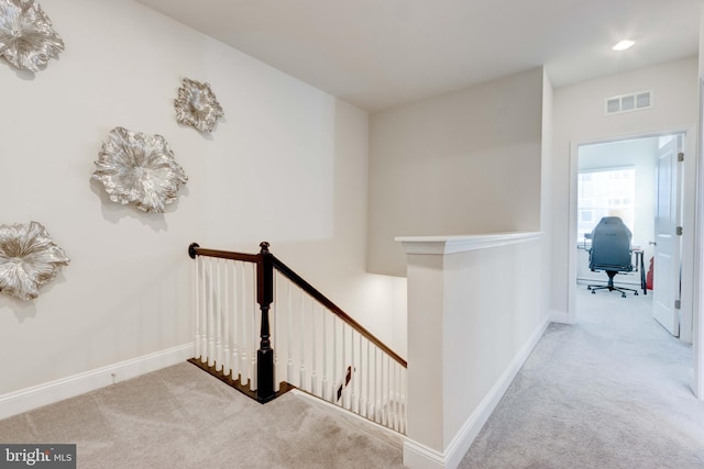 hallway with light carpet