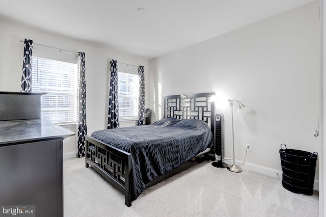 bedroom featuring light colored carpet