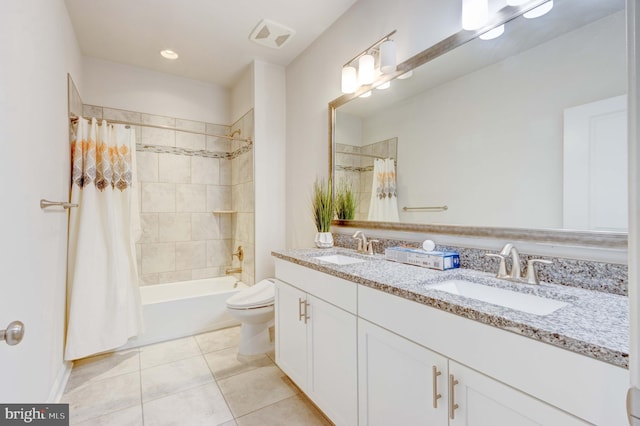 full bathroom featuring vanity, tile patterned floors, toilet, and shower / bath combo with shower curtain