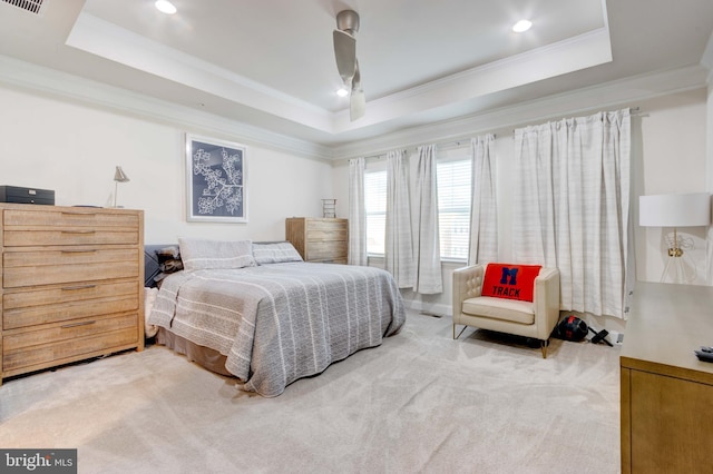 bedroom featuring crown molding, carpet, and a tray ceiling