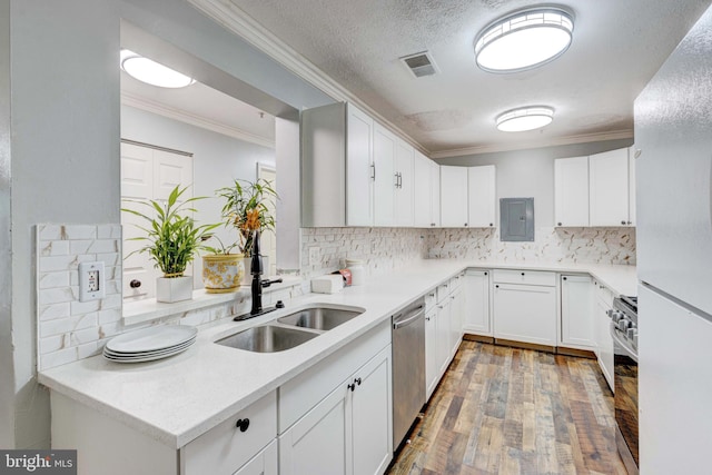 kitchen featuring decorative backsplash, sink, white cabinetry, and stainless steel appliances