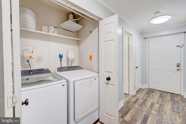 clothes washing area featuring hardwood / wood-style flooring, separate washer and dryer, and crown molding