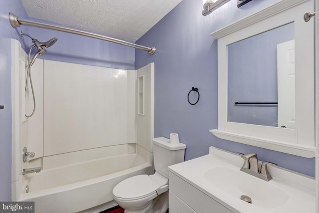 full bathroom featuring a textured ceiling, washtub / shower combination, vanity, and toilet