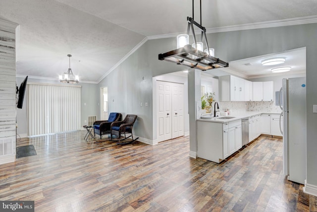 kitchen featuring stainless steel dishwasher, white cabinetry, refrigerator, a chandelier, and lofted ceiling