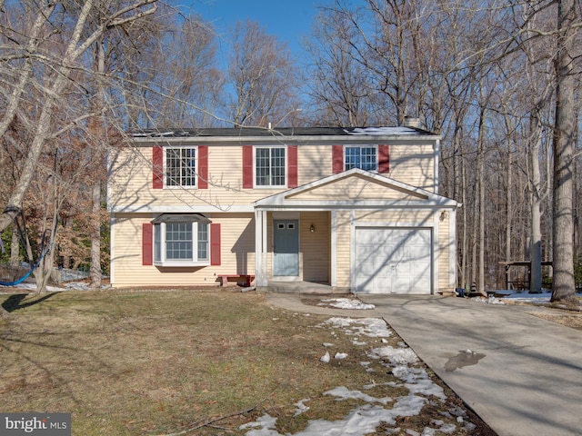 view of front of home featuring a garage and a front lawn