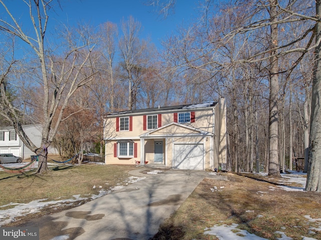 view of front of home with a yard and a garage