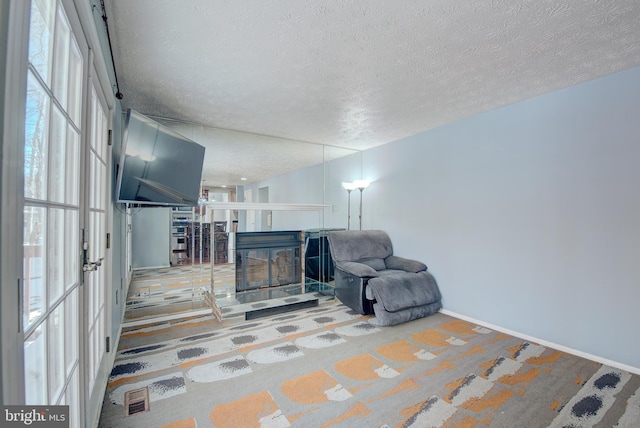 living area featuring a textured ceiling