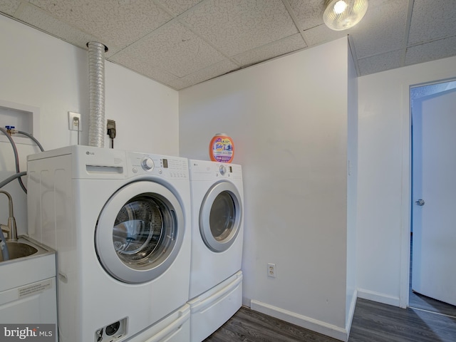 laundry area with dark wood-type flooring and washer and clothes dryer