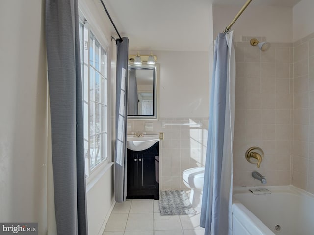 full bathroom with tile patterned floors, vanity, tile walls, toilet, and shower / bath combo with shower curtain