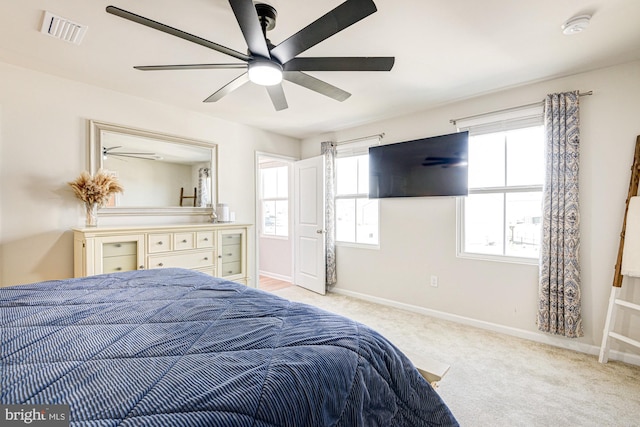 bedroom with light carpet, visible vents, a ceiling fan, and baseboards