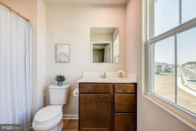 full bathroom with vanity, toilet, a shower with curtain, and baseboards